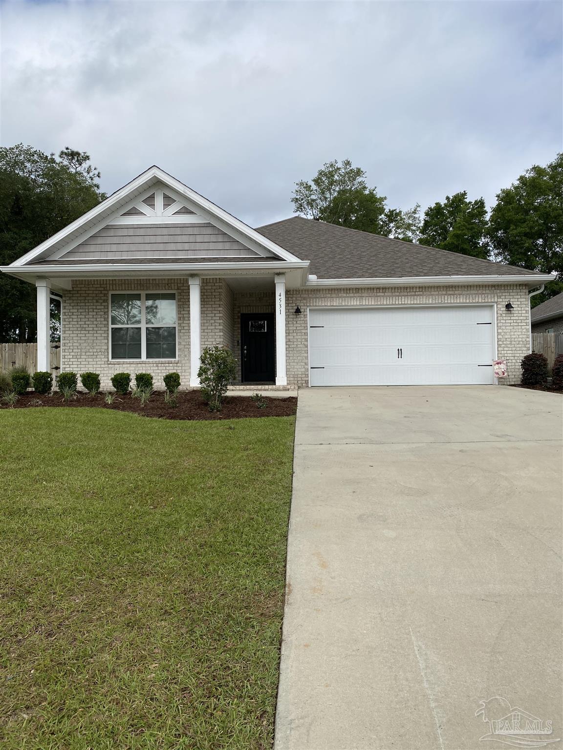 4531 Jude Way Pace, FL 32571 - Photo 2 of 43 a front view of a house with a yard and potted plants