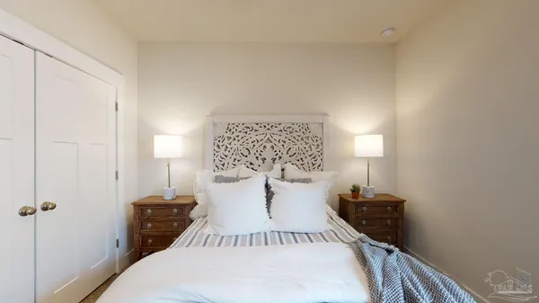 a bedroom with a bed and lamp