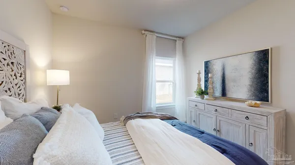 a bedroom with a bed and a flat screen television