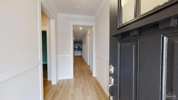a view of a hallway with a wooden floor