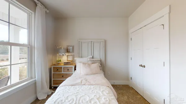 a view of a bedroom with wooden floor