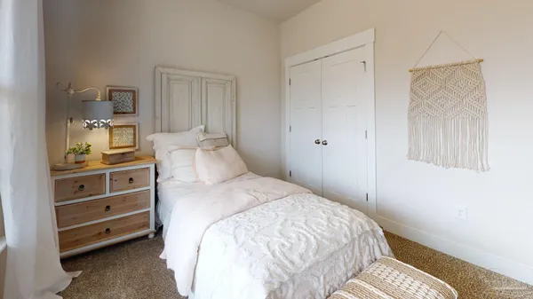 a bedroom with a bed and a cabinets
