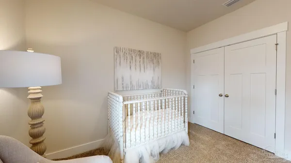 a bedroom with a bed and a chair