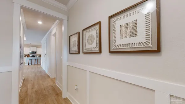 a view of a hallway with wooden floor and staircase