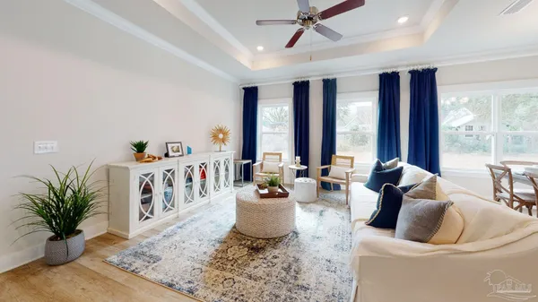 a living room with furniture and large windows