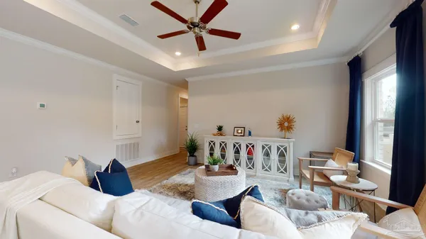 a bedroom with a bed a couch and a window