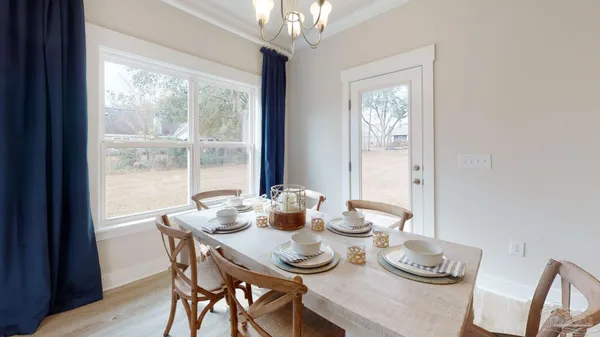 a dining room with furniture window and wooden floor
