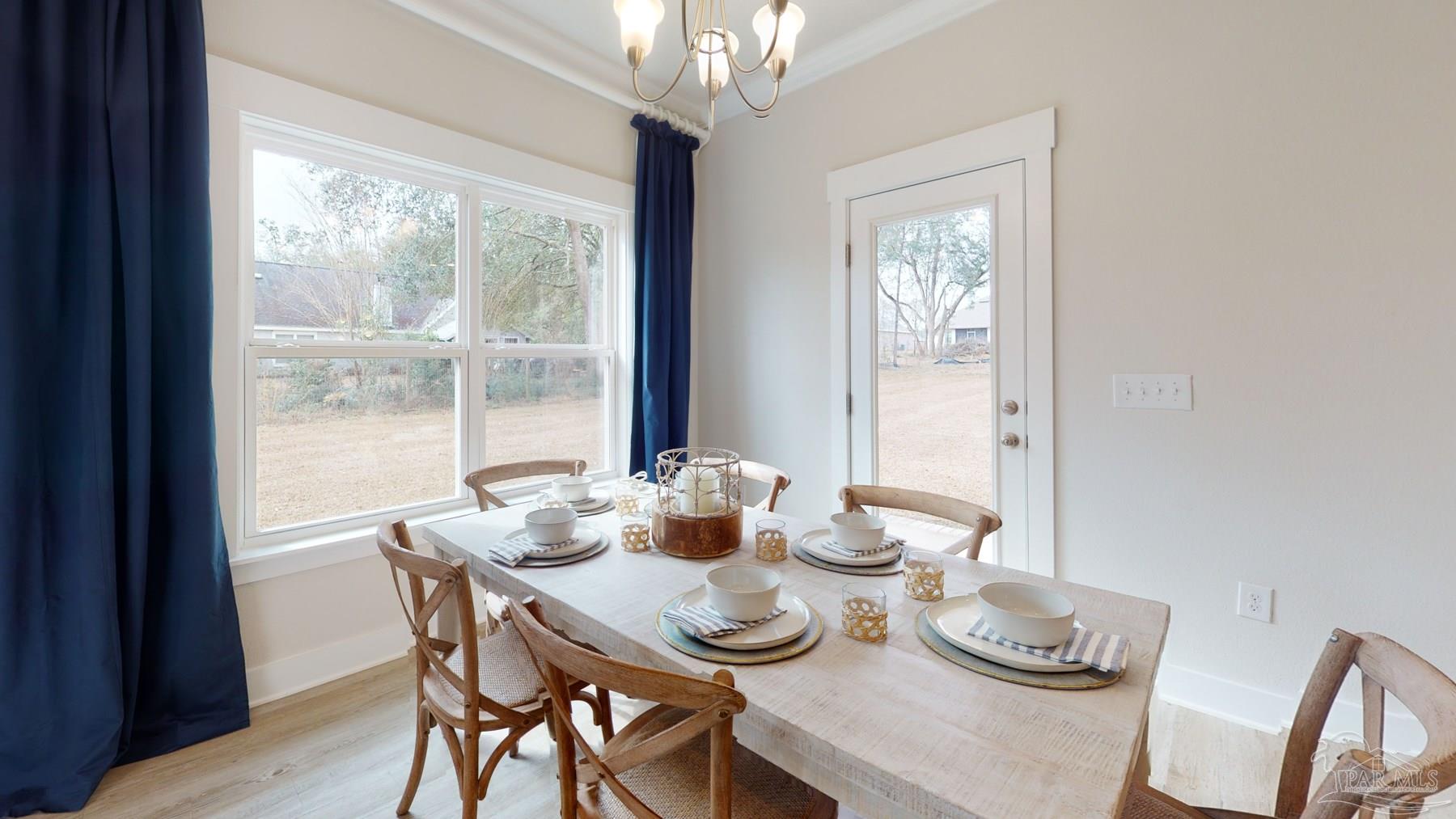 4531 Jude Way Pace, FL 32571 - Photo 9 of 43 a dining room with furniture window and wooden floor