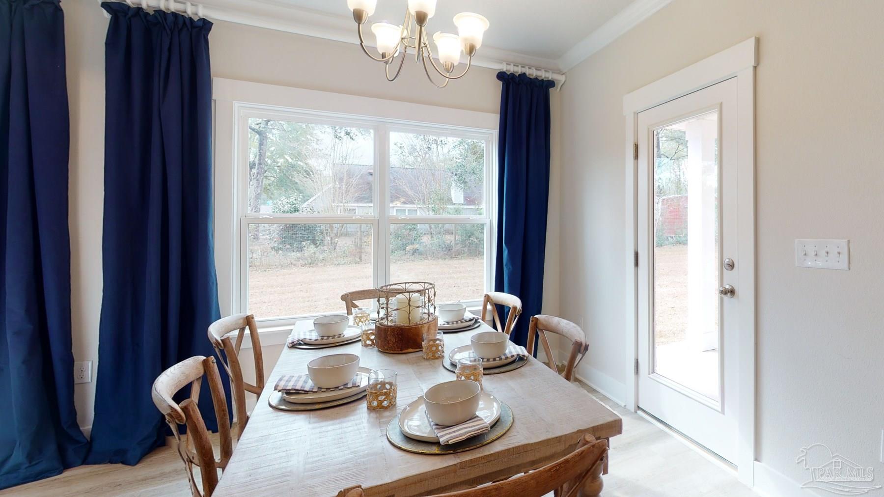 4531 Jude Way Pace, FL 32571 - Photo 10 of 43 a dining room with furniture a chandelier and window