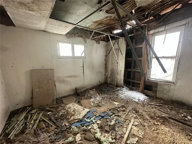 a view of walk in closet with window and entryway