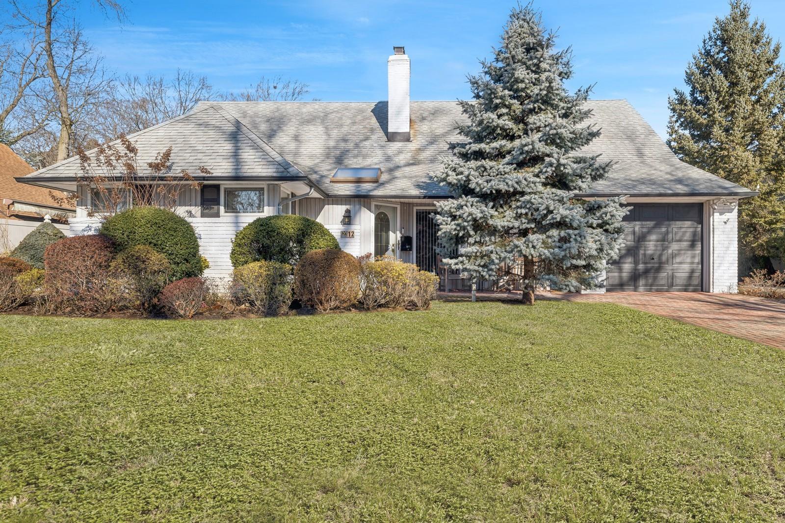 12 Ranch Place Merrick, NY 11566 - Photo 1 of 1 a view of a house with garden and a tree