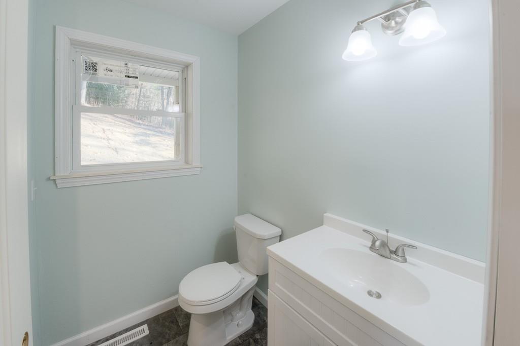 123 Bethany Road Monson, MA 01057 - Photo 11 of 41 a white toilet sitting next to a bathroom sink