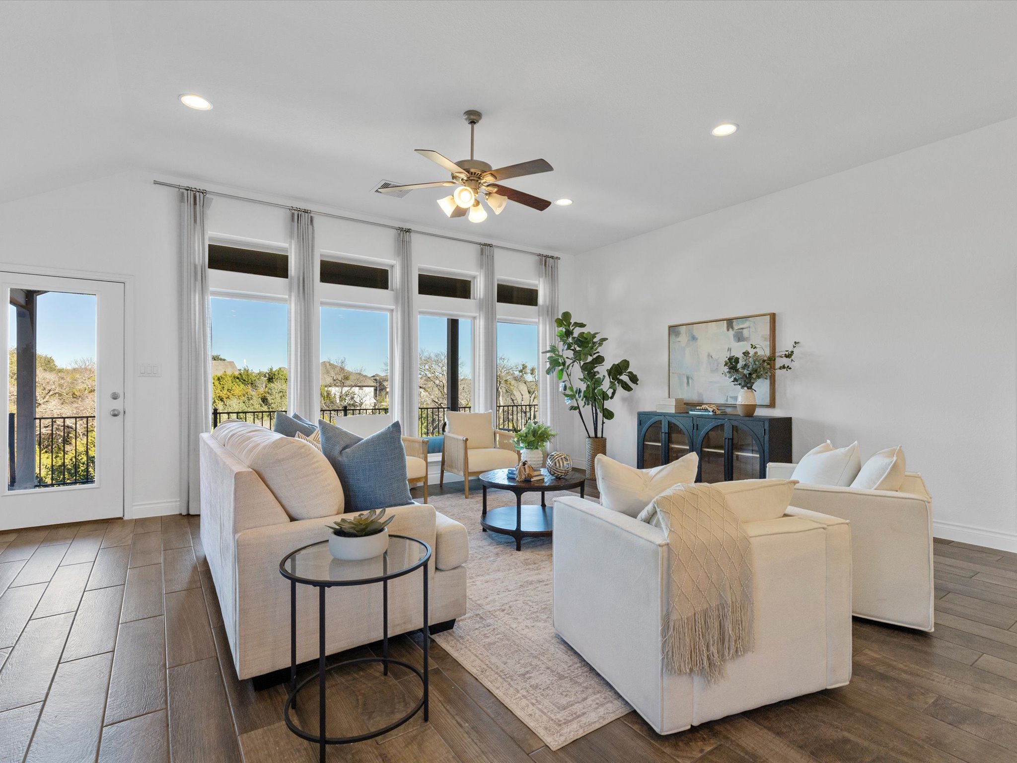 1009 Deer Rim Road Leander, TX 78641 - Photo 11 of 40 Tall ceilings, oversized windows, neutral finishes, recessed lighting, and durable wood-look tile flooring give the home a bright, clean feel.