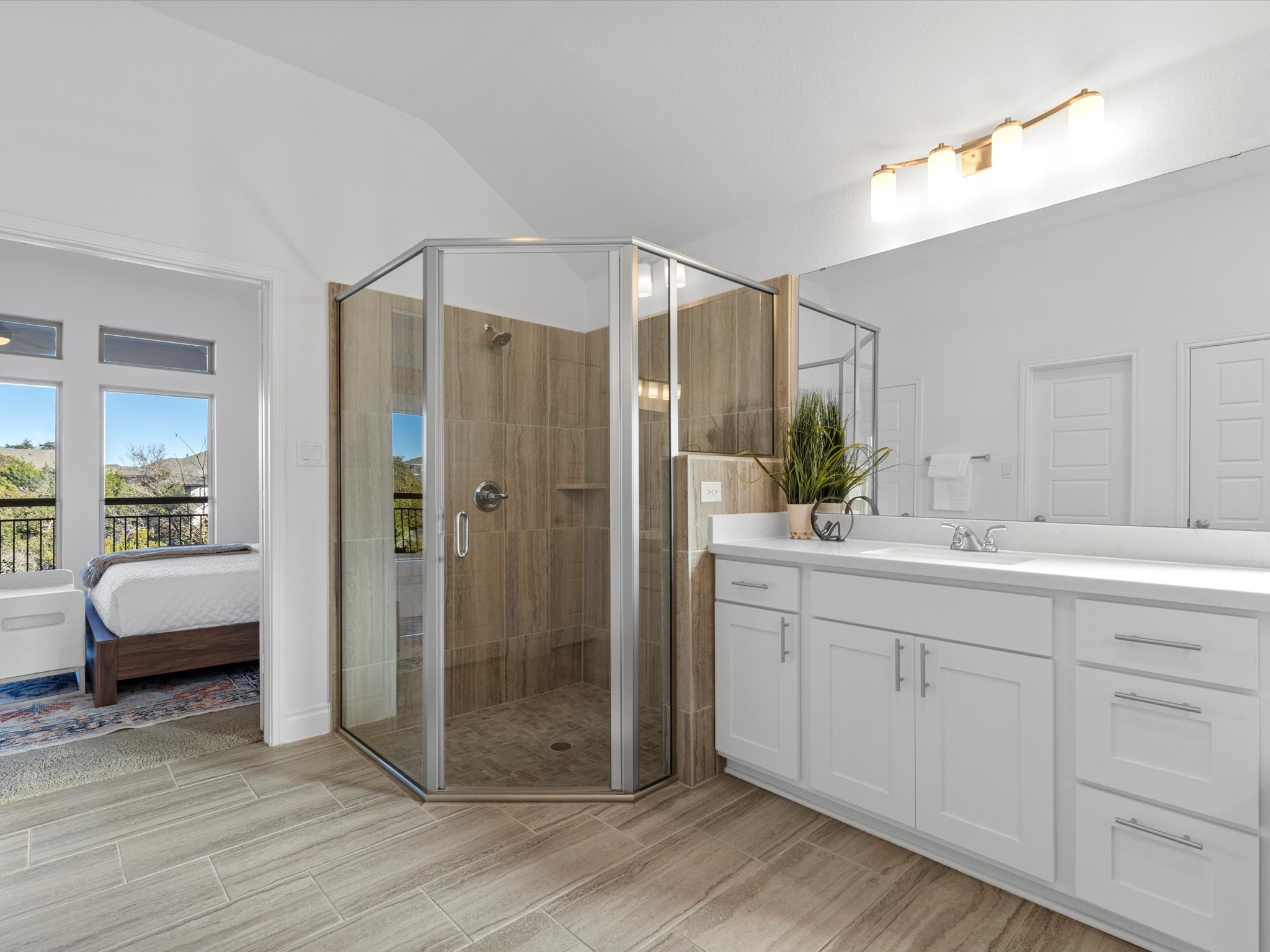 1009 Deer Rim Road Leander, TX 78641 - Photo 15 of 40 Soak away the day's stress in the corner tub and enjoy an XL walk-in shower with tile surround.