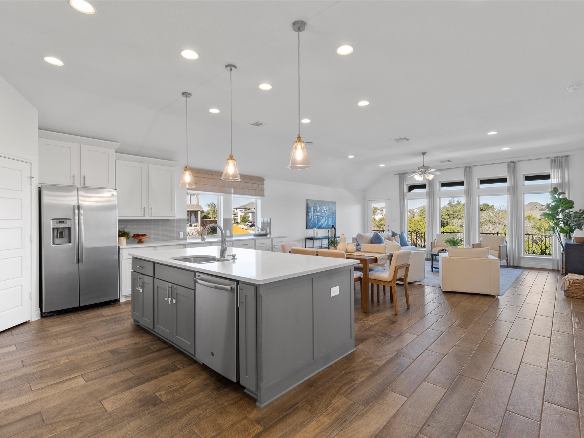 a kitchen with stainless steel appliances granite countertop a lot of cabinets and wooden floor