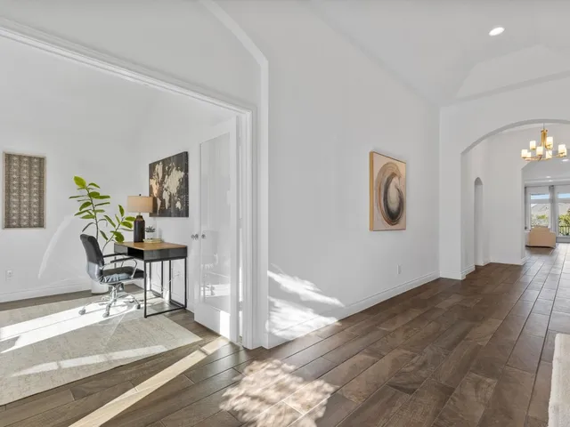 a view of a hallway with wooden floor and a fireplace