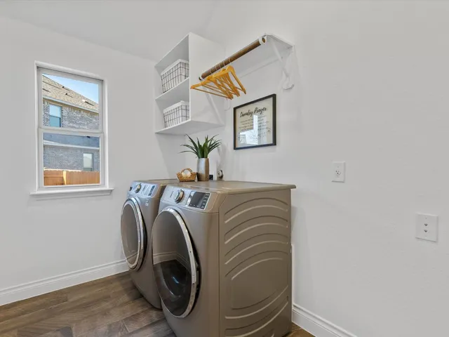 an empty room with a window and a ceiling fan