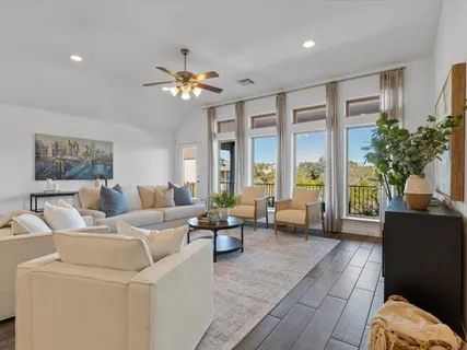a living room with furniture and a chandelier