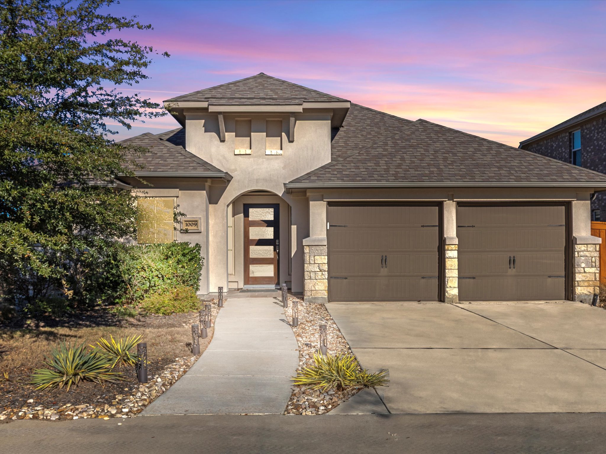 1009 Deer Rim Road Leander, TX 78641 - Photo 4 of 40 a front view of a house with a yard