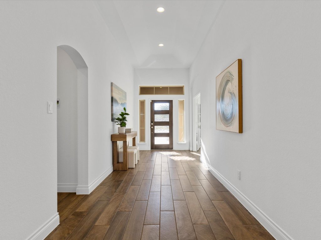 1009 Deer Rim Road Leander, TX 78641 - Photo 6 of 40 Inside a long, wide entry foyer flows past the home office and secondary bedrooms into the main living area.