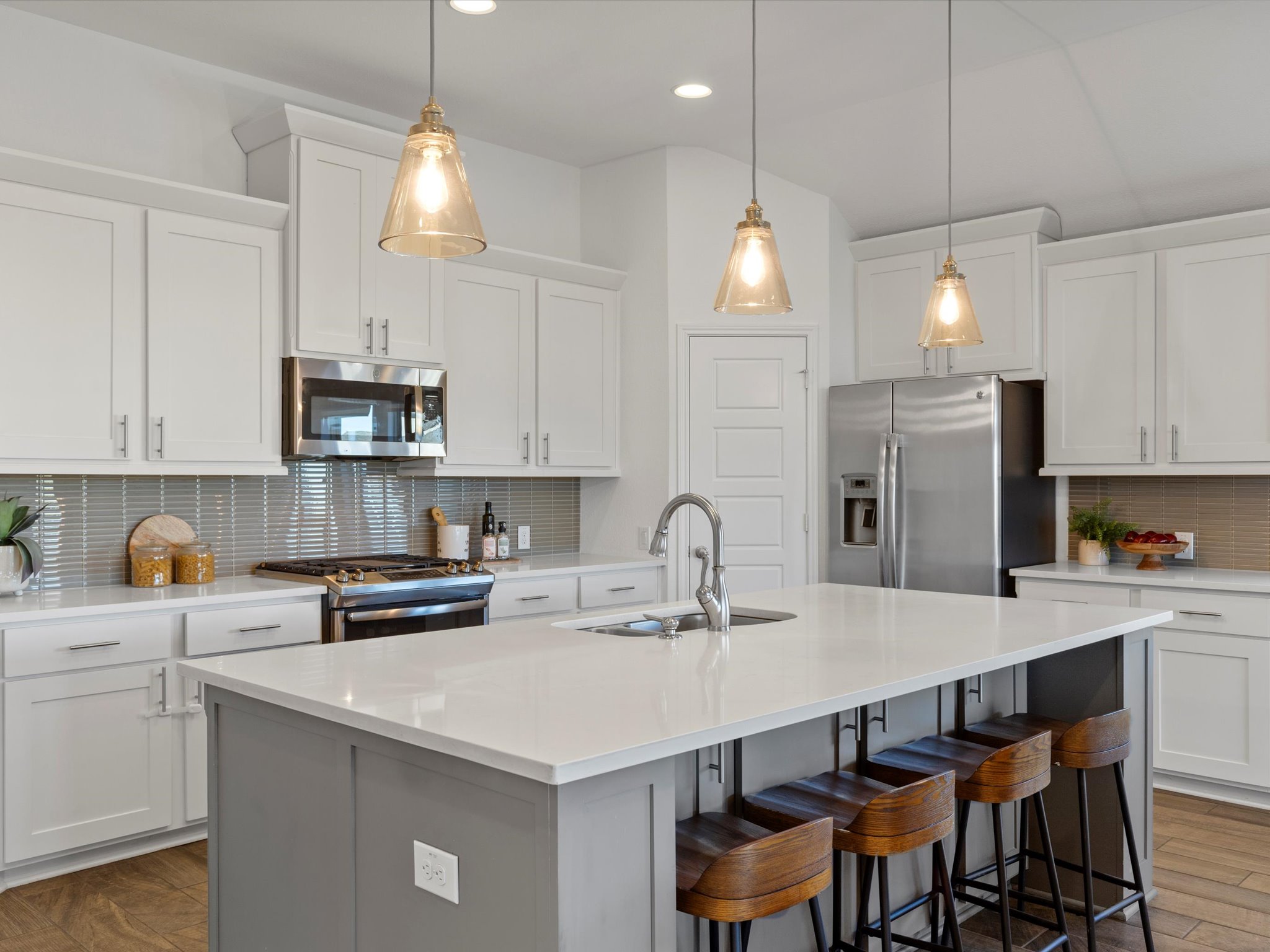 1009 Deer Rim Road Leander, TX 78641 - Photo 6 of 40 a kitchen with kitchen island granite countertop a sink a center island and cabinets