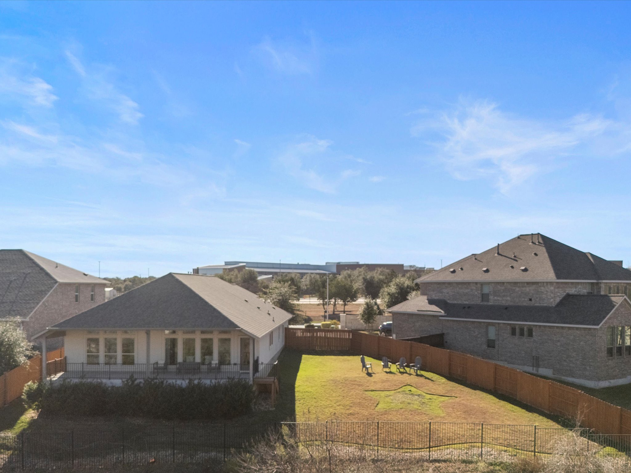 1009 Deer Rim Road Leander, TX 78641 - Photo 8 of 40 The over quarter-acre lot features manicured landscaping, a spacious side yard, tall privacy fencing, and a gently sloped backyard with wrought iron fencing that preserves the greenbelt views.