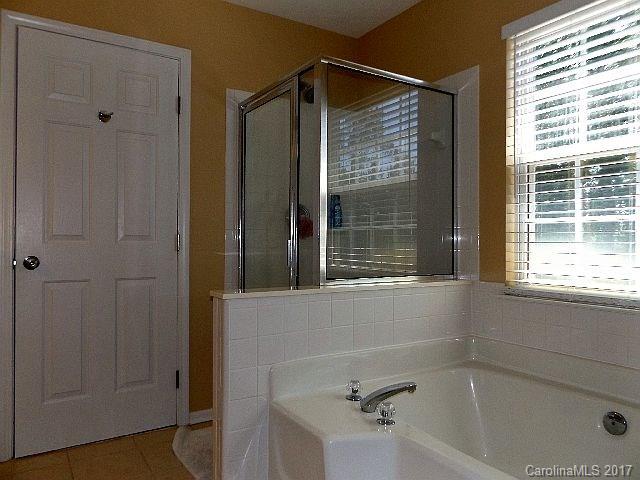 1033 Kilpatrick Lane Fort Mill, SC 29708 - Photo 14 of 24 a bathroom with a bathtub and window