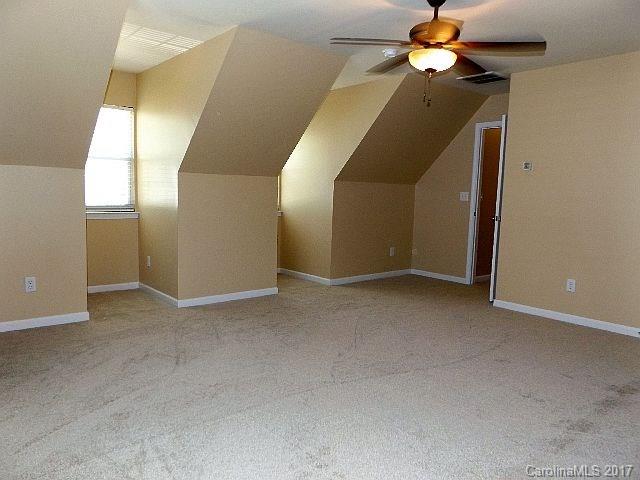 1033 Kilpatrick Lane Fort Mill, SC 29708 - Photo 19 of 24 a view of a hallway with a chandelier fan