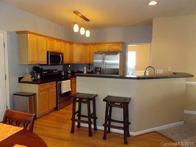 1033 Kilpatrick Lane Fort Mill, SC 29708 - Photo 5 of 24 a kitchen with stainless steel appliances granite countertop a sink a stove a microwave a counter top space and cabinets