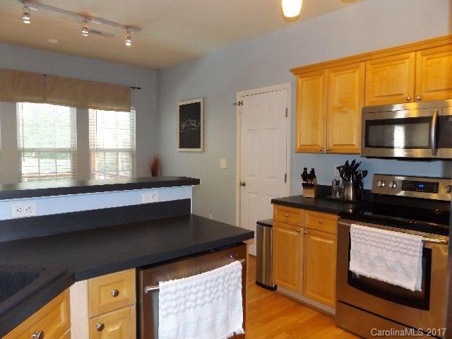 1033 Kilpatrick Lane Fort Mill, SC 29708 - Photo 6 of 24 a kitchen with stainless steel appliances a stove a sink and a microwave