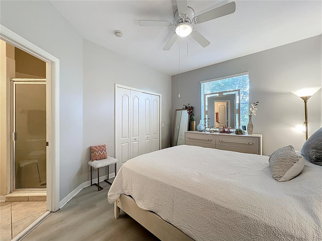 3309 Wilshire Way Road, Unit 3 Orlando, FL 32829 - Photo 20 of 43 a bedroom with a bed and a mirror on a dresser