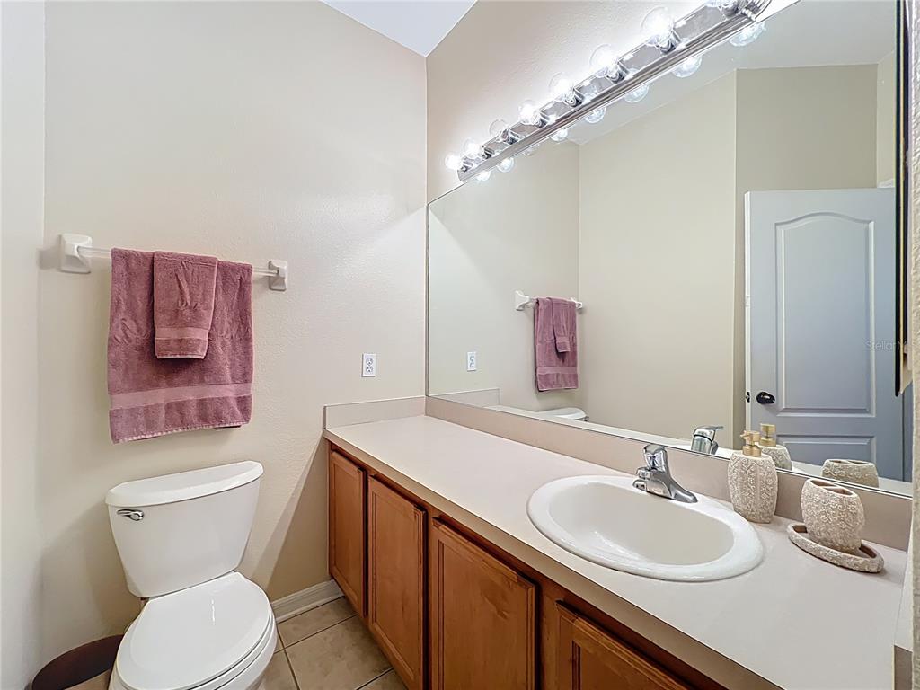 3309 Wilshire Way Road, Unit 3 Orlando, FL 32829 - Photo 22 of 43 a bathroom with a toilet a sink a mirror and vanity