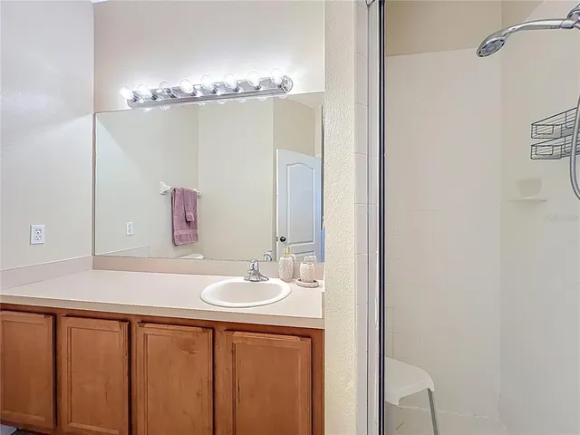 a bathroom with a double vanity sink and a mirror