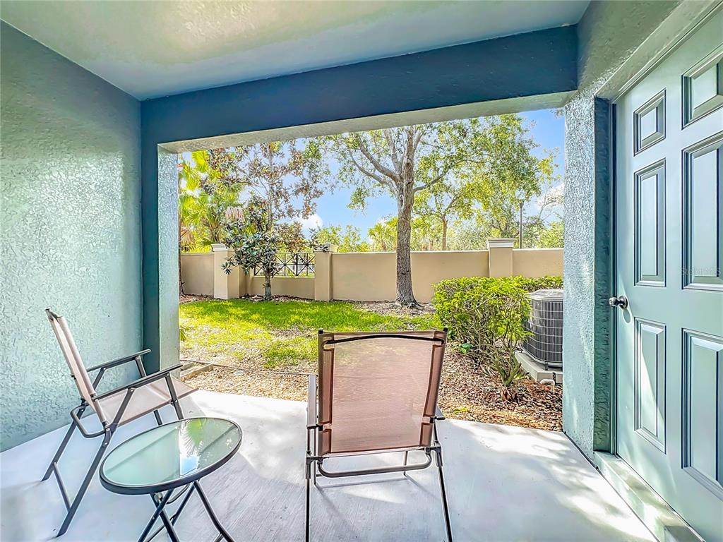 3309 Wilshire Way Road, Unit 3 Orlando, FL 32829 - Photo 25 of 43 a view of a porch with chairs and backyard