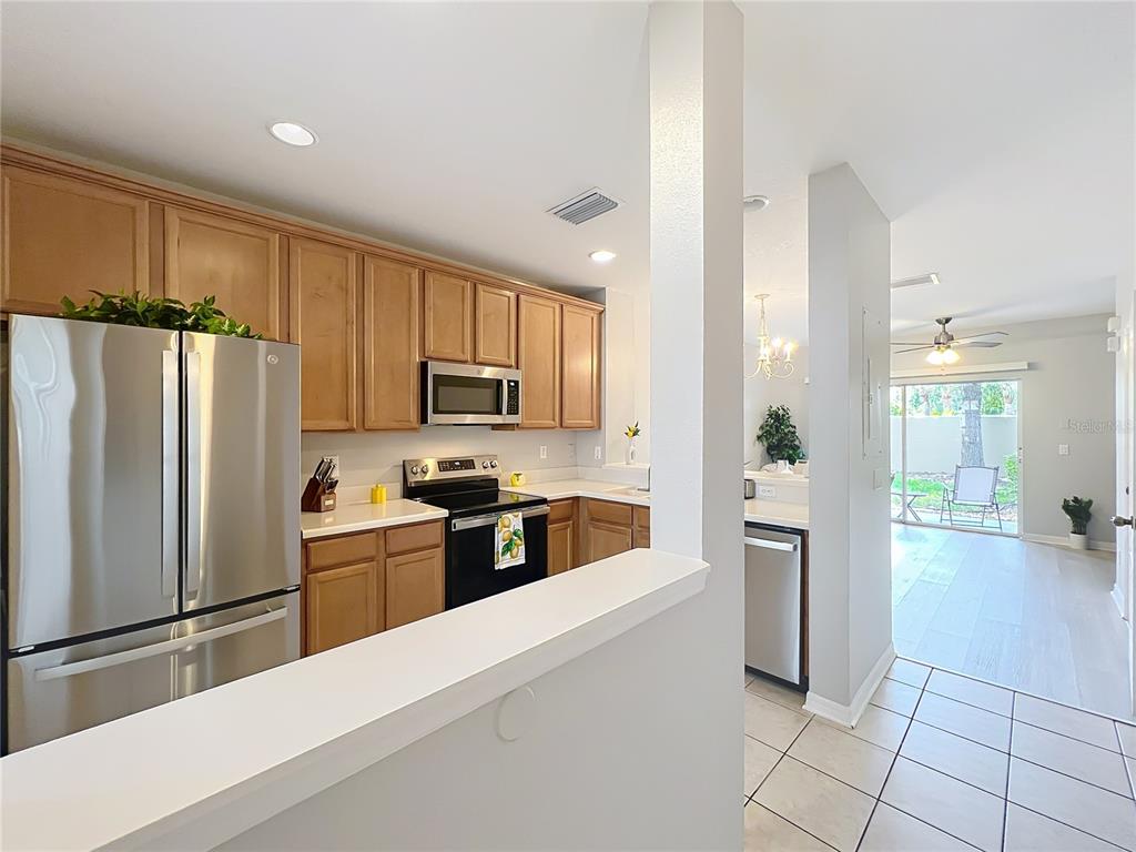 3309 Wilshire Way Road, Unit 3 Orlando, FL 32829 - Photo 6 of 43 a large kitchen with cabinets and stainless steel appliances