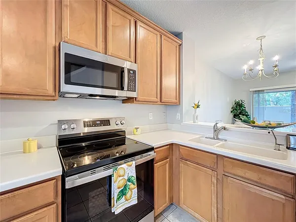 a kitchen with a sink stove and microwave