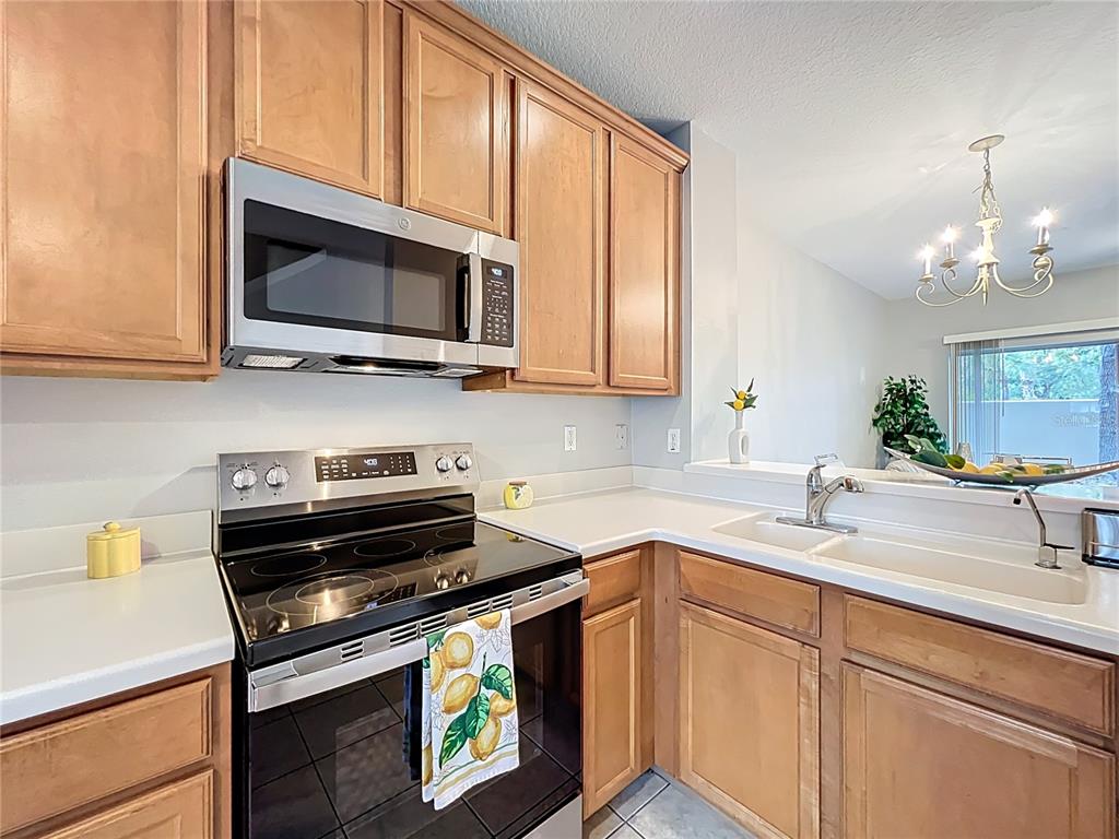 3309 Wilshire Way Road, Unit 3 Orlando, FL 32829 - Photo 8 of 43 a kitchen with a sink stove and microwave