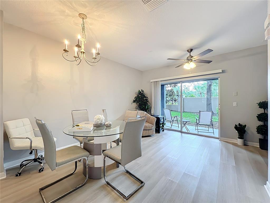 3309 Wilshire Way Road, Unit 3 Orlando, FL 32829 - Photo 10 of 43 a view of a dining room with furniture wooden floor and chandelier