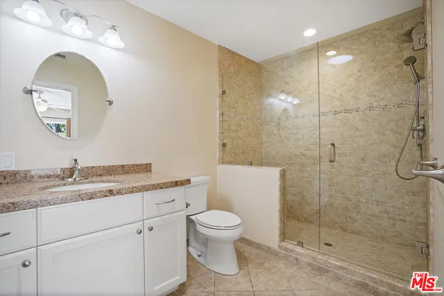 a bathroom with a toilet sink and shower