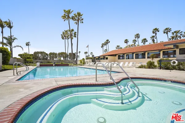 a swimming pool with view of outdoor seating