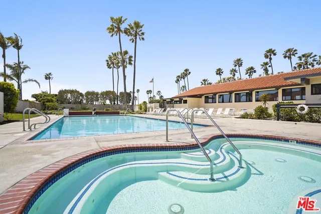 a swimming pool with view of outdoor seating