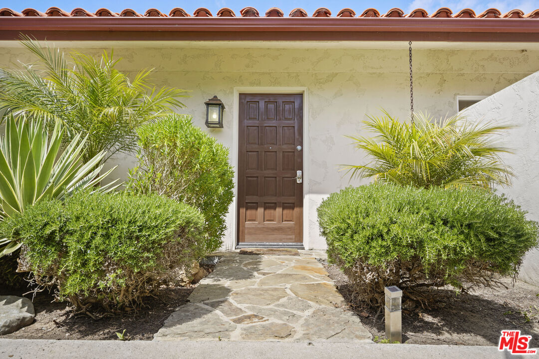 29500 Heathercliff Road, Unit A Malibu, CA 90265 - Photo 2 of 21 a front view of a house with a yard