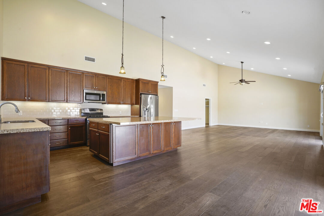 29500 Heathercliff Road, Unit A Malibu, CA 90265 - Photo 4 of 21 a kitchen with stainless steel appliances granite countertop a sink a stove and a refrigerator