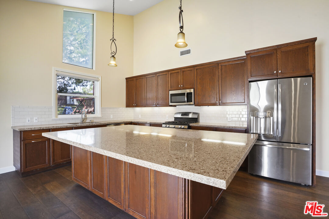 29500 Heathercliff Road, Unit A Malibu, CA 90265 - Photo 5 of 21 a kitchen with stainless steel appliances granite countertop a sink a microwave a refrigerator and a stove