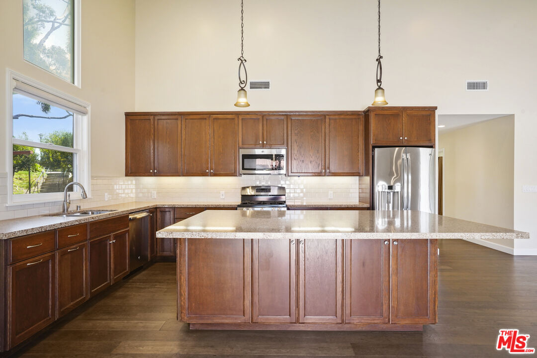 29500 Heathercliff Road, Unit A Malibu, CA 90265 - Photo 6 of 21 a kitchen with stainless steel appliances granite countertop a sink a stove and a refrigerator