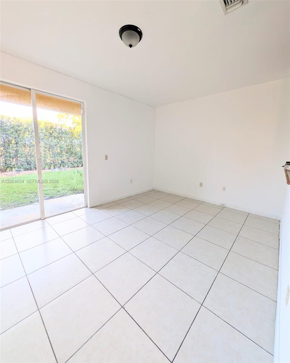 12080 Southwest 268th Street, Unit 27 Homestead, FL 33032 - Photo 3 of 6 a view of an empty room with a window