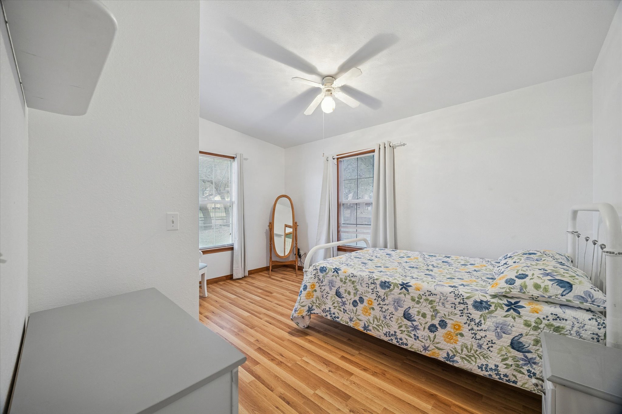 3502 1869th Ranch Liberty Hill, TX 78642 - Photo 16 of 20 Bedroom featuring light wood-style flooring and a ceiling fan