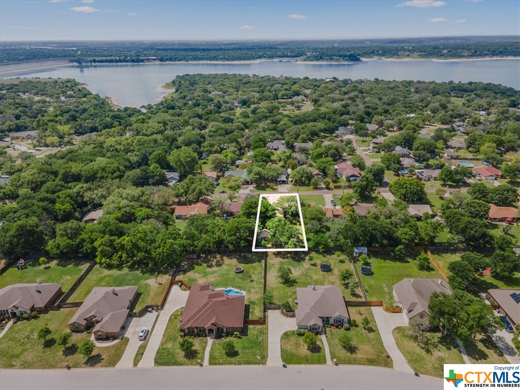an aerial view of residential houses with outdoor space and street view