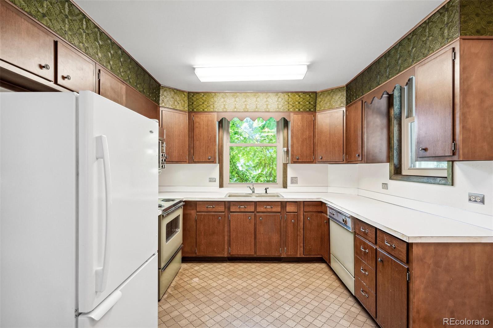 3921 Meade Street Denver, CO 80211 - Photo 12 of 27 a kitchen with a sink refrigerator and window