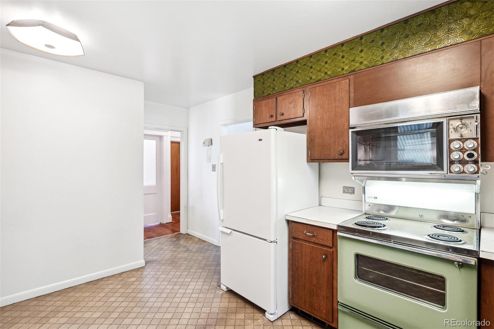 3921 Meade Street Denver, CO 80211 - Photo 14 of 27 a kitchen with a sink and a refrigerator